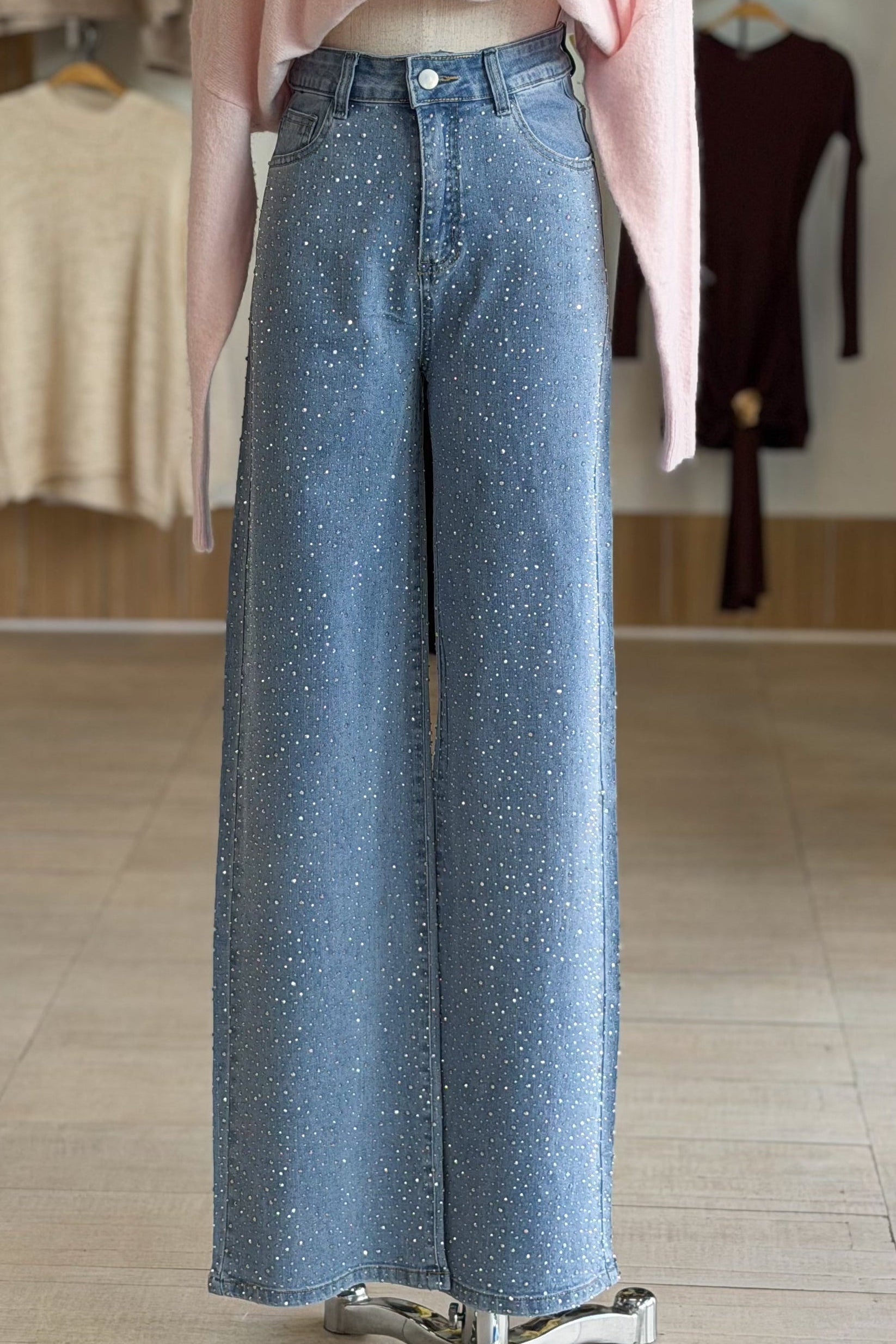 Blue jeans on a mannequin with a blurred clothing store background