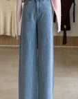 Blue jeans on a mannequin with a blurred clothing store background