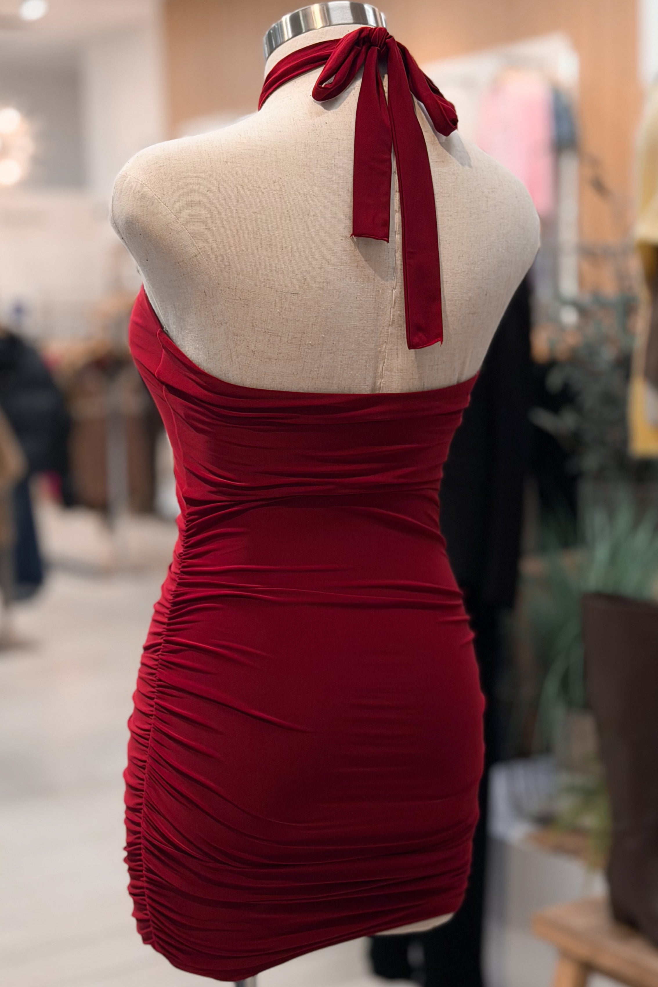 Red dress on a mannequin in a store setting