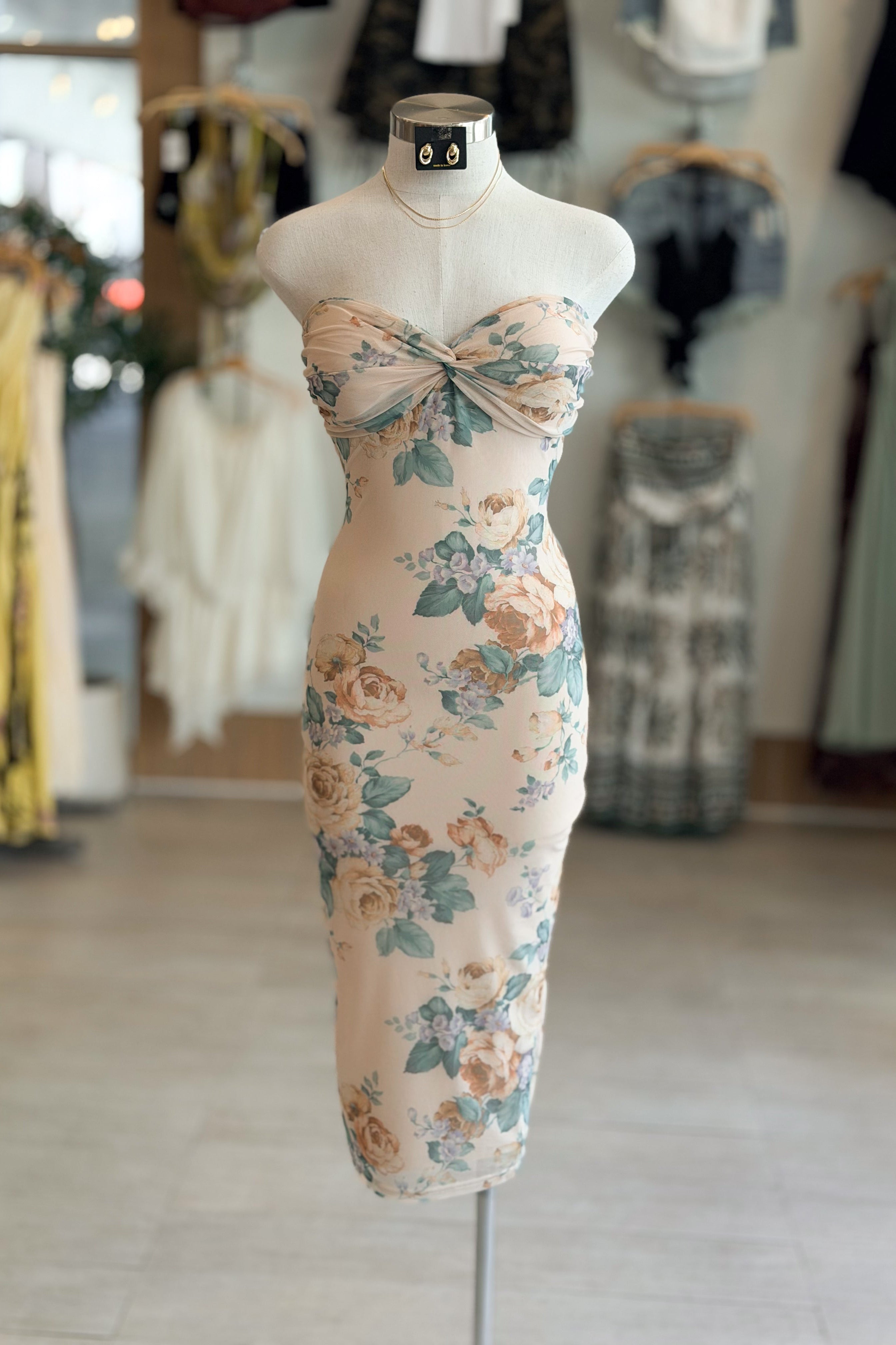 Floral dress on a mannequin in a clothing store setting