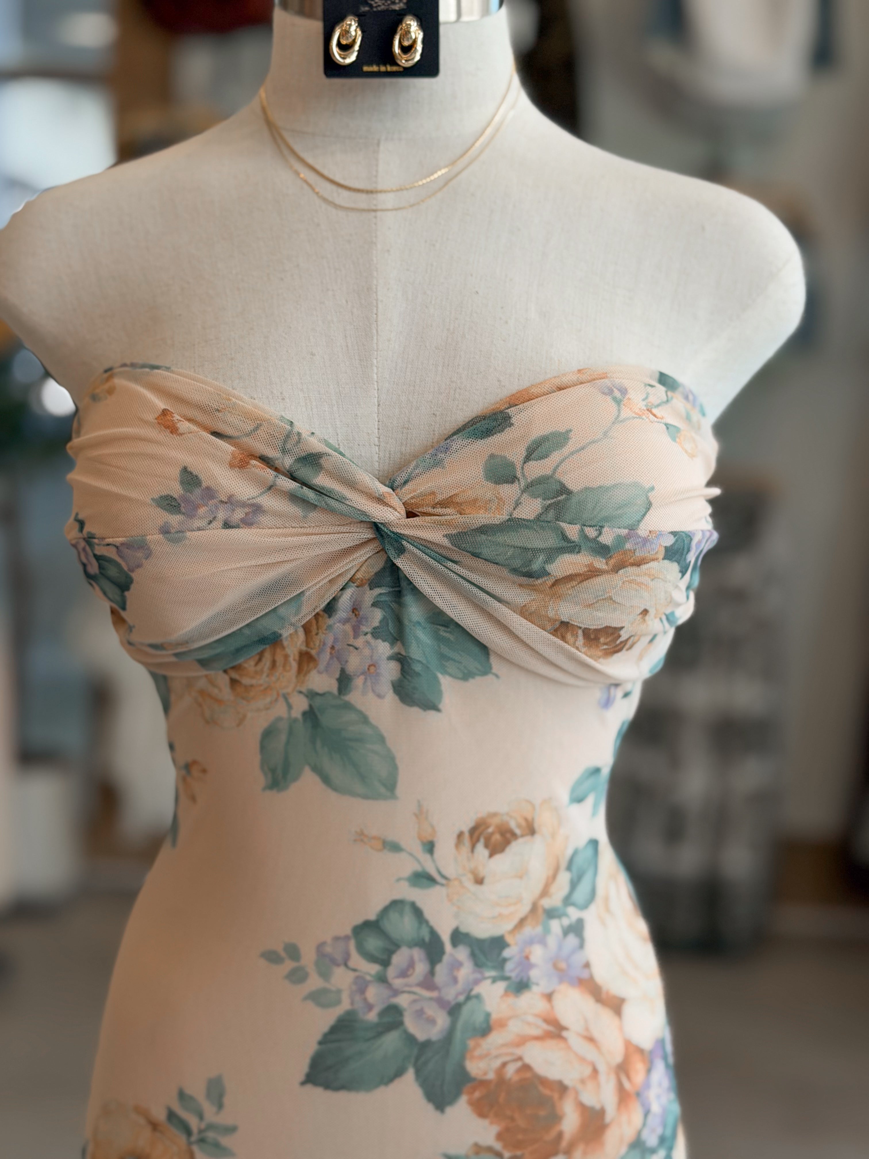 Floral dress on a mannequin with a blurred background