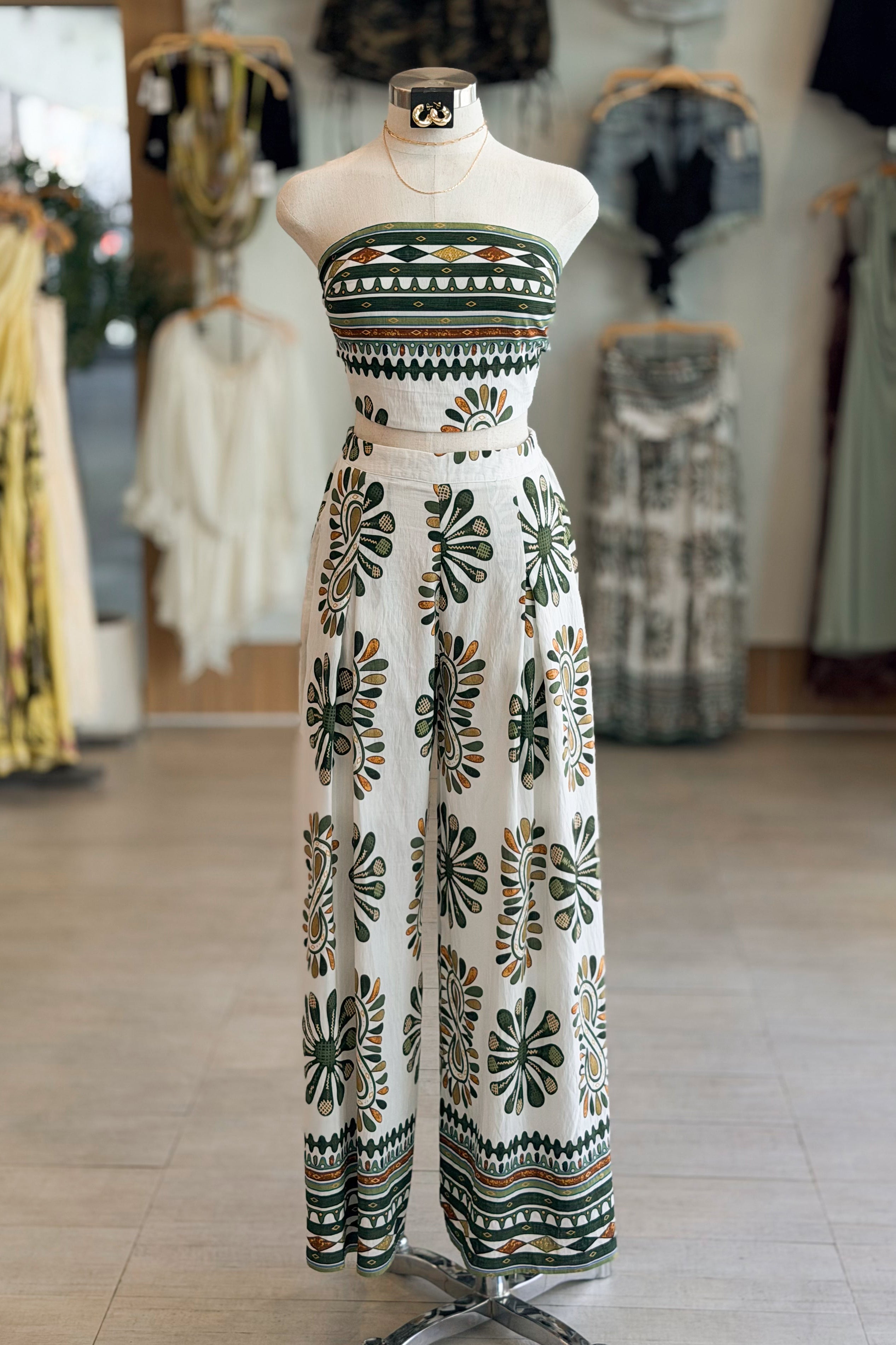 Mannequin wearing a patterned dress in a clothing store setting